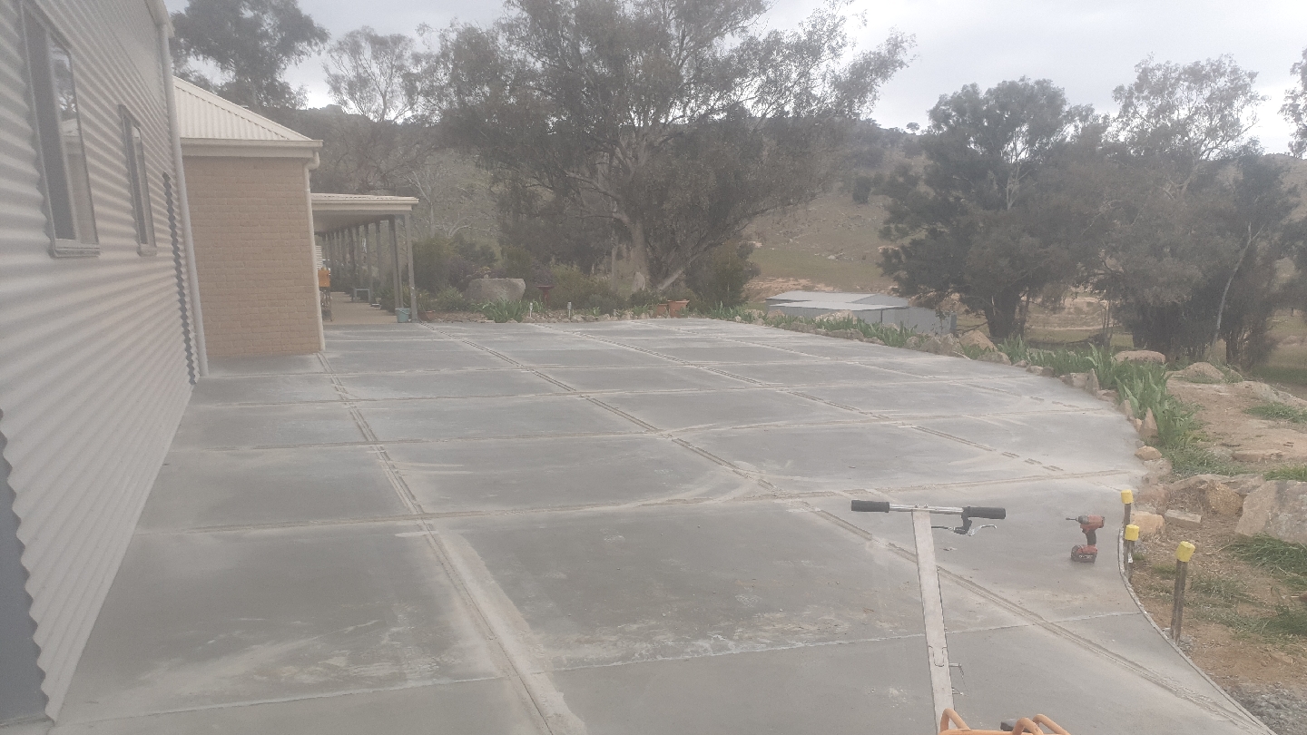 Wide finished slab along a rural home with bushland behind